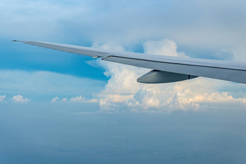 Flying and traveling, view from airplane window on the wing on sunset time 