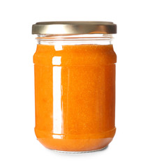 Glass jar of tasty apricot jam on white background