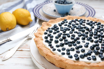 Tasty bilberry pie on table