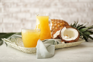 Composition with fresh pineapple juice and coconut on table