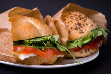 Veggie burger with tomatoes, mozzarella, arugula, paprika and olives 