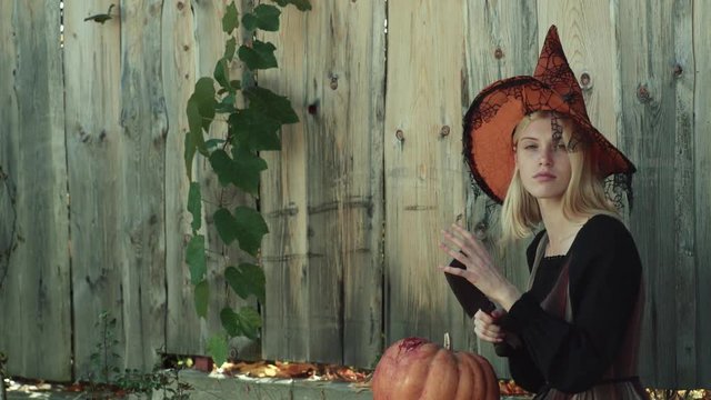 Happy Halloween girl. Emotional young women in Halloween costumes. Happy Halloween with funny woman. Girl play with pumpkins and treat.