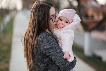 Obraz premium Young mother with her little baby. Mom hold baby on hands. Happy family