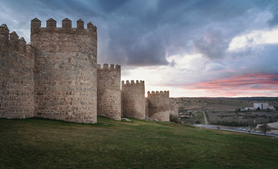 Fototapeta na wymiar Medieval Walls of Avila City at sunset - Avila, Castile and Leon, Spain