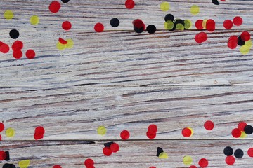 October 3, happy German independence Day. the concept of patriotism , freedom and independence. black, yellow and red confetti on wooden background