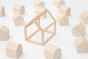 Models of miniature wooden houses with a big house in the center