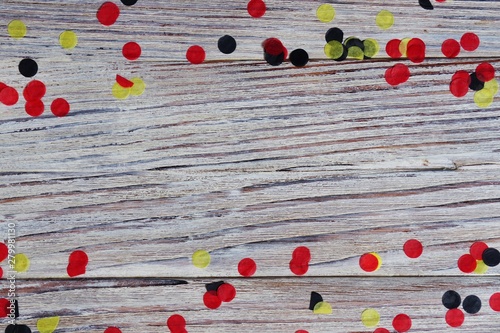 October 3, happy German independence Day. the concept of patriotism , freedom and independence. black, yellow and red confetti on wooden background