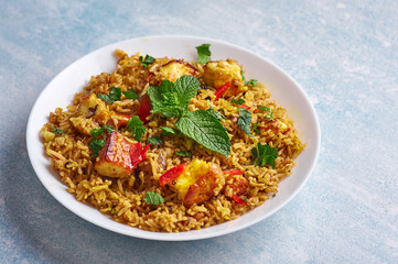 vegetarian paneer biryani at blue background. paneer biryani is traditional veg indian cuisine dish with paneer, basmati rice, masala, chili, mint. Copy space