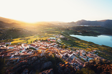 Aerial view of Zahara de la Sierra city at sunset - Zahara de la Sierra, Cadiz Province, Andalusia, Spain - obrazy, fototapety, plakaty