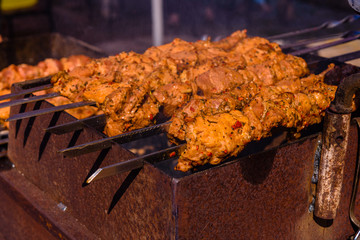 Skewers with meat over the charcoals. Cooking shashlik