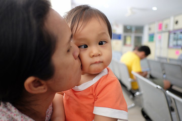 Fototapeta premium Asian mother carrying a baby.