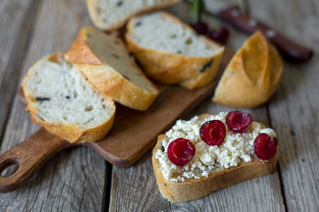 sliced sourdough toast with creamy yogurt and fresh cherries. Vintage wooden table, rustic style