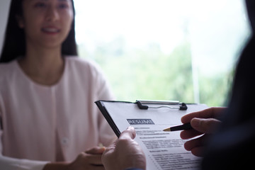 Executives are interviewing candidates. Focusing on resume writing tips, applicant qualifications, interview skills and pre-interview preparation. Considerations for new employees
