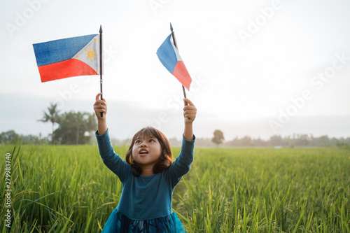 happy phillipine kid with national flag outdoor