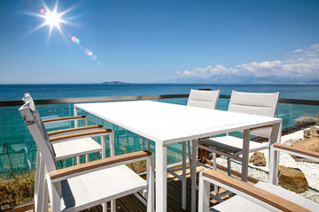 White table with chairs on the beautiful ocean view.