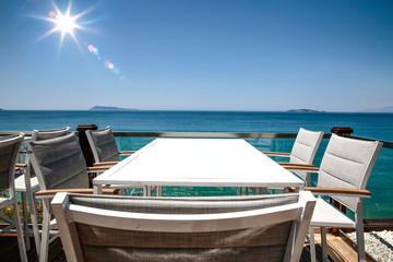 White table with chairs on the beautiful ocean view.