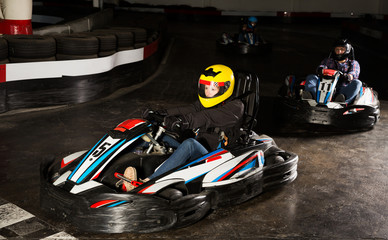  woman driving racing car at kart circuit