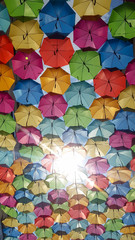 Fototapeta na wymiar Street decoration with colorful open umbrellas hanging in Bordeaux city in sunny day France