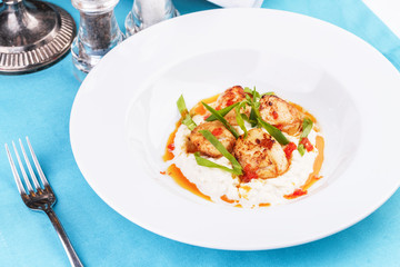  Mediterranean fish on a mashed potato pillow with tomato sauce
