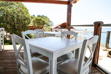 White table with chairs on the beautiful ocean view.