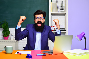 Bearded professor at school lesson in classroom. Teacher is skilled leader. Teachers day. Knowledge and educational school concept. Happy male student studying in school. Good teachers enjoy teaching.