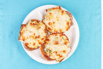 European recipe, Mediterranean dish. Baked mollusks in the oven under the cheese cap and greens according to the national recipe