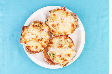European recipe, Mediterranean dish. Baked mollusks in the oven under the cheese cap and greens according to the national recipe