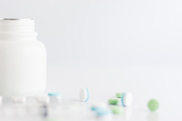 Syringe ,white bottle of medicine with pill on white background