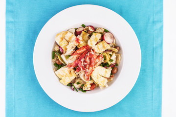  European recipe, Mediterranean dish. Roast vegetables - radish, greens, onions, olives, cabbage, with pasta in a creamy sauce with crab meat and fish pieces.