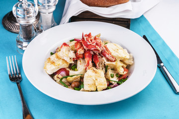  European recipe, Mediterranean dish. Roast vegetables - radish, greens, onions, olives, cabbage, with pasta in a creamy sauce with crab meat and fish pieces.