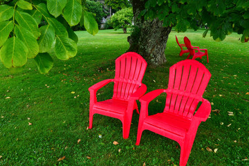 Stockbridge, Massachusetts, USA Red garden chairs on the grounds of the Norman Rockwell Museum.