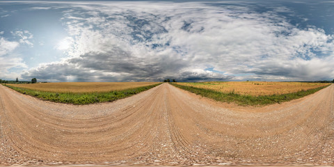 full seamless spherical hdri panorama 360 degrees angle view on gravel road among fields with...