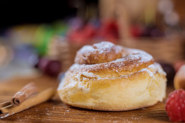 Homemade cinnamon roll bun with cinnamon sticks selective focus