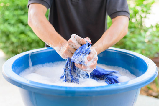 Washing Clothes In A Bucket Of Water. Stock Photo, Picture and Royalty Free  Image. Image 11764670.