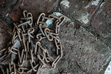 Rusty chain on the brickwork. The symbol of slave labor