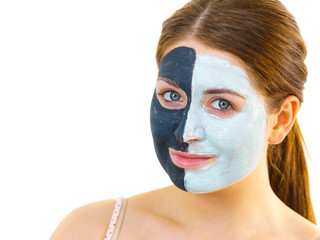 Girl with black white mud mask on face