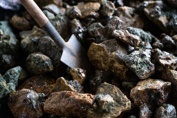 Mining. A miniature shovel and pieces of minerals with crystals.