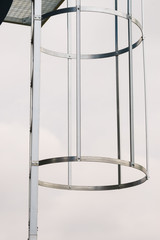 Industrial metal ladder with round railing
