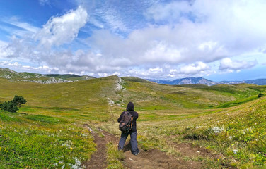 Mountain Chatyr Dag, Crimea. Tourist standing back over beautiful view on mountains and blue sky in summer. - 279993907