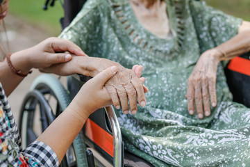 Elderly asian woman on wheelchair at home with daughter take care