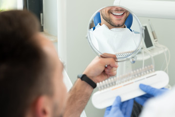 Handsome young man in stomatology clinic