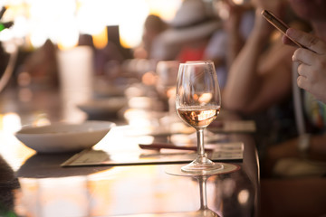 glasses of white wine on a table in restaurant, selective focus