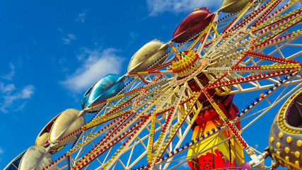 The carousel in amusement park, close-up. The Carousel is spinning against the blue sky © creative_content