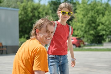 Outdoor summer portrait of father and daughter, happy smiling dad with child