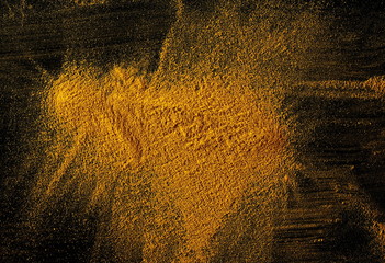 Turmeric powder isolated on black background and texture, top view