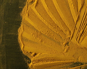 Turmeric powder isolated on black background and texture, top view