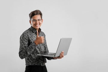 Young Indian / Asian man working on laptop