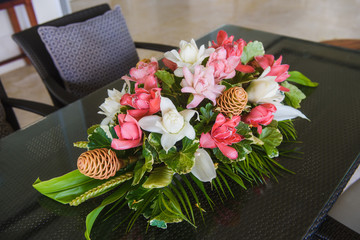 Pink and white flower composition at table