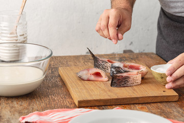 Man prepares carp river fish in home kitchen. Cooking healthy and diet food