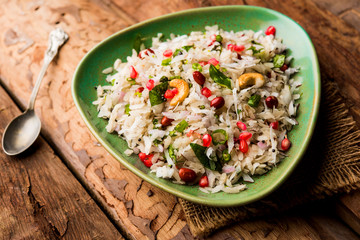 Dapde Pohe is a typical Maharashtrian breakfast, made with thin variety of poha and fresh coconut with chilli, peanuts and nuts. served in a bowl or plate. selective focus